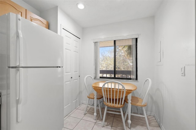 dining room with baseboards and light tile patterned floors