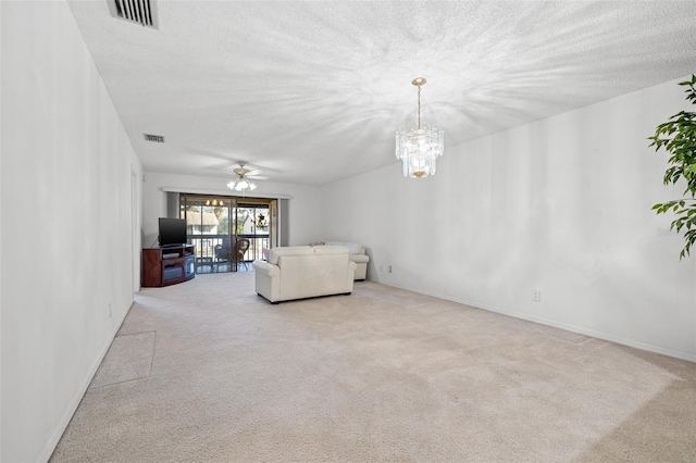 unfurnished living room with carpet, visible vents, a textured ceiling, and ceiling fan with notable chandelier