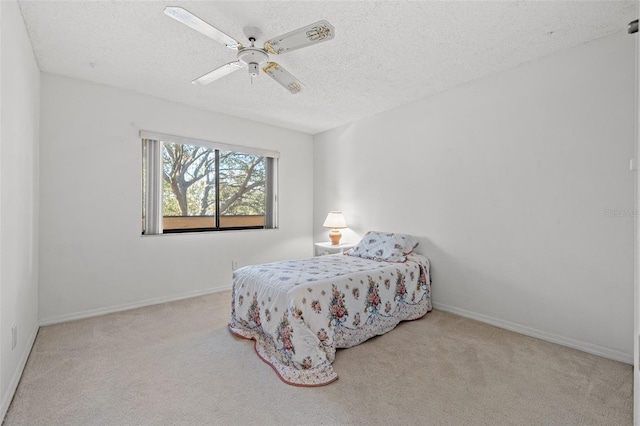 bedroom featuring carpet floors, a textured ceiling, baseboards, and a ceiling fan