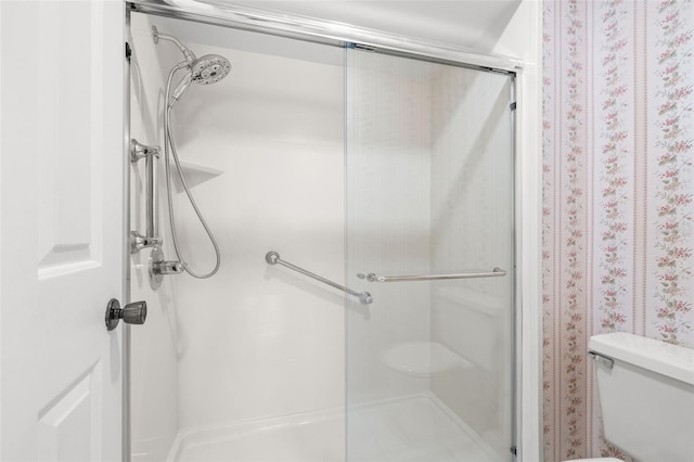 full bath with a stall shower and toilet