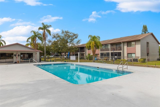 pool featuring fence and a patio