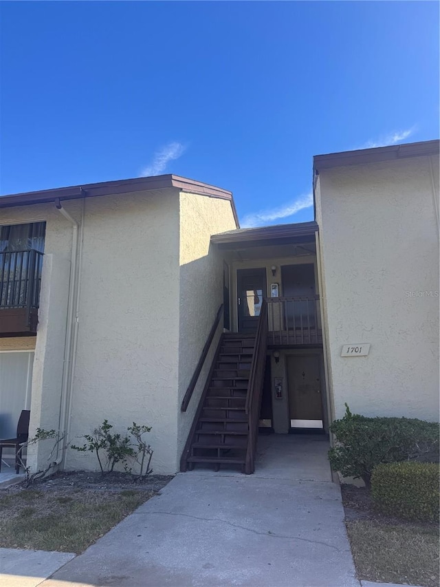 doorway to property with stucco siding