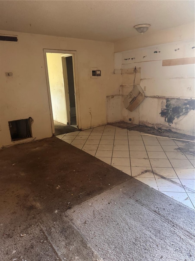 spare room featuring tile patterned flooring and visible vents