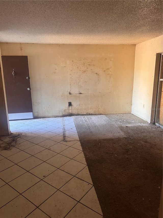 unfurnished room with a textured ceiling