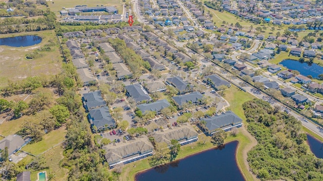 drone / aerial view featuring a water view and a residential view