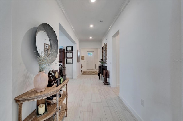 hallway featuring ornamental molding, recessed lighting, and baseboards