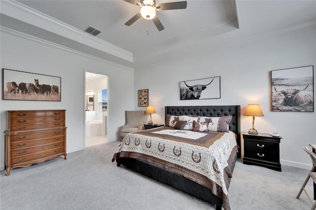 carpeted bedroom featuring visible vents, a raised ceiling, connected bathroom, ceiling fan, and ornamental molding