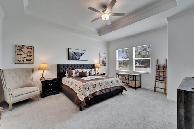 bedroom featuring crown molding, a raised ceiling, light colored carpet, ceiling fan, and baseboards
