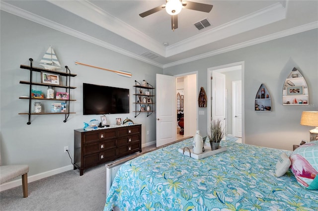 bedroom featuring light carpet, visible vents, baseboards, ornamental molding, and a tray ceiling