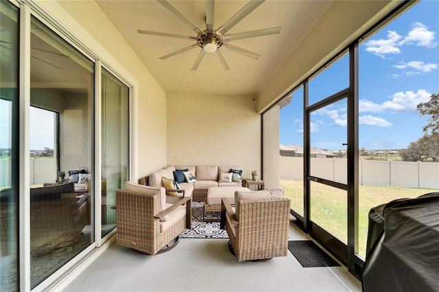 sunroom featuring a ceiling fan and a healthy amount of sunlight