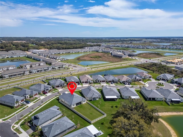 drone / aerial view featuring a residential view and a water view