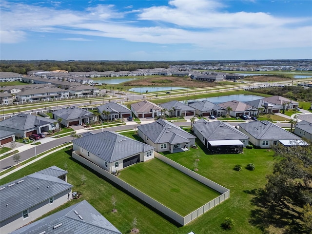 birds eye view of property featuring a residential view and a water view