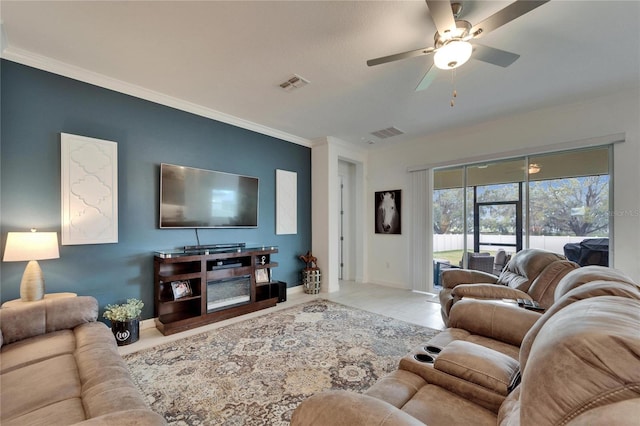 living room with ornamental molding, visible vents, and baseboards
