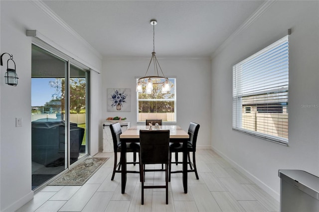 dining area with a healthy amount of sunlight and crown molding