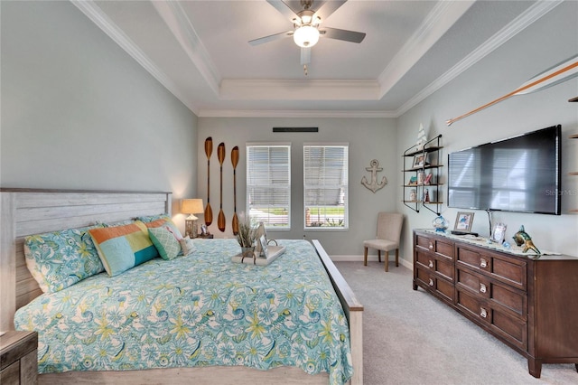 bedroom with light carpet, baseboards, a tray ceiling, and crown molding
