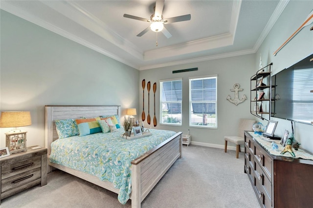 bedroom featuring light carpet, baseboards, ornamental molding, and a raised ceiling