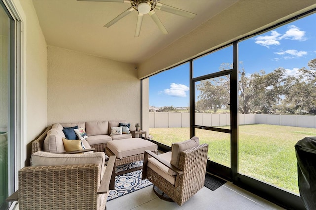 sunroom featuring ceiling fan