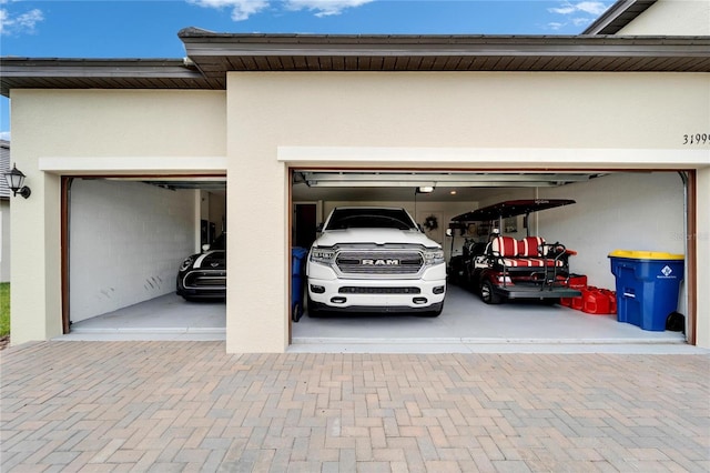 garage with decorative driveway