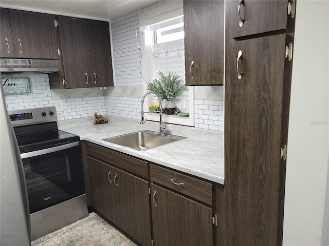 kitchen with under cabinet range hood, a sink, electric range, and dark brown cabinets