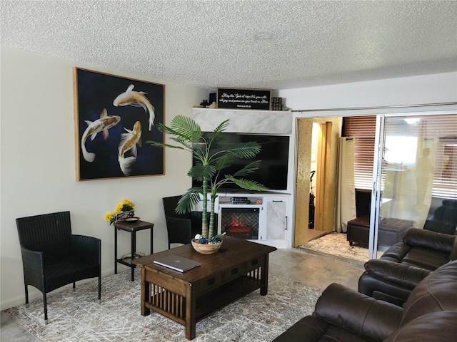 living room featuring concrete floors and a textured ceiling