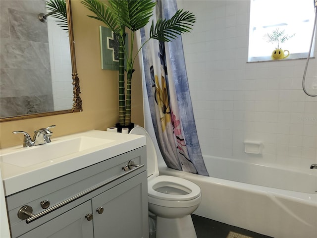 bathroom featuring vanity, toilet, and shower / bath combo with shower curtain