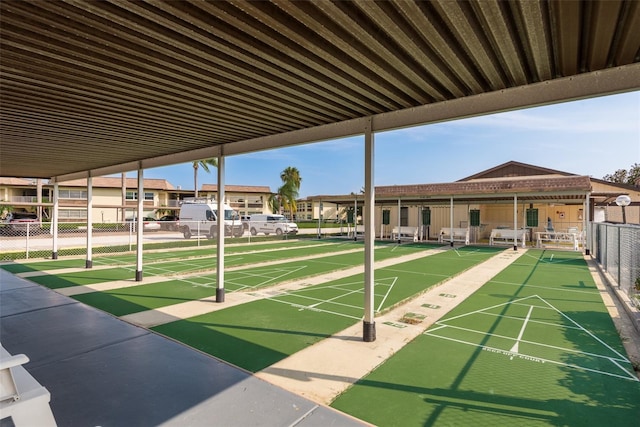 surrounding community with fence and shuffleboard