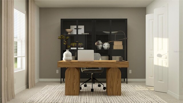 home office with baseboards and light colored carpet