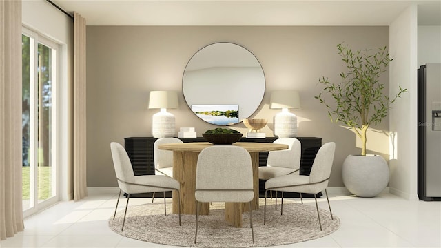 dining space featuring tile patterned flooring and baseboards