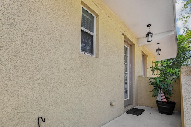 property entrance with stucco siding