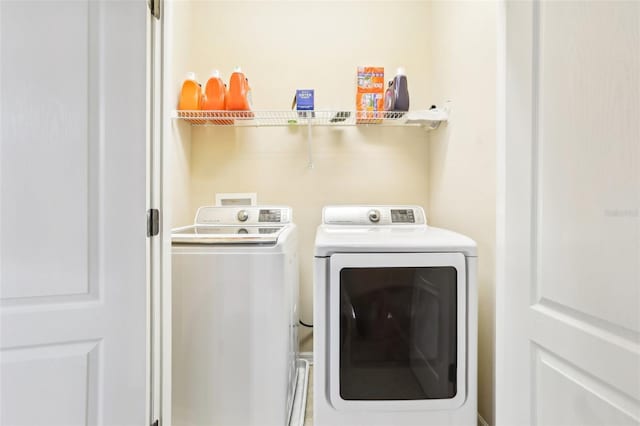 laundry room featuring washing machine and dryer and laundry area