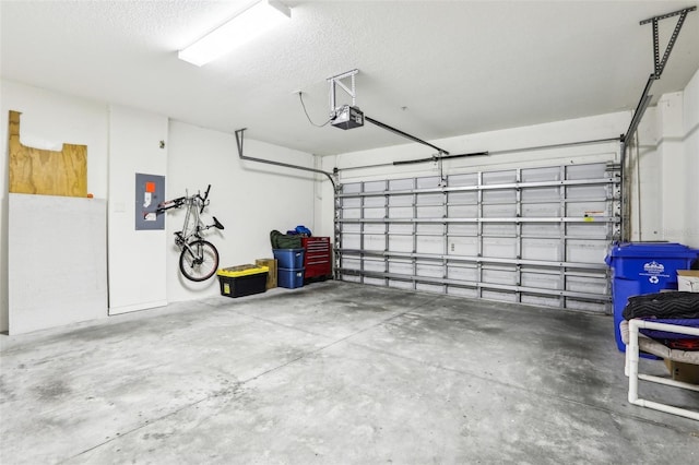 garage with electric panel and a garage door opener