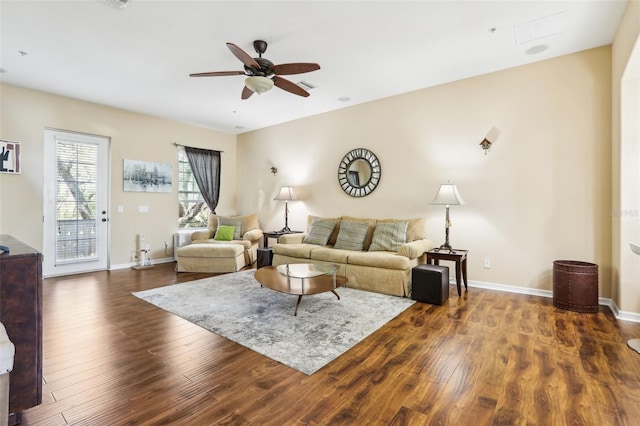 living area featuring wood finished floors, ceiling fan, and baseboards