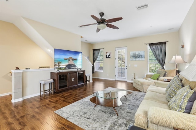living room with visible vents, ceiling fan, wood finished floors, and baseboards