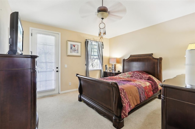 bedroom with light colored carpet, baseboards, and ceiling fan