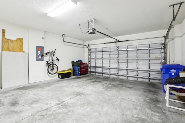 garage with a garage door opener and electric panel