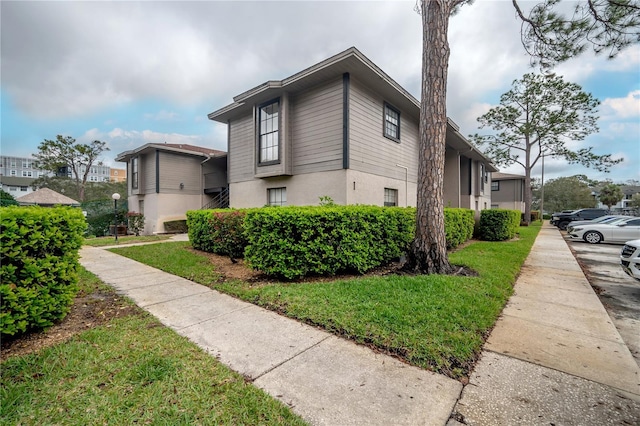 view of home's exterior featuring stucco siding and a yard