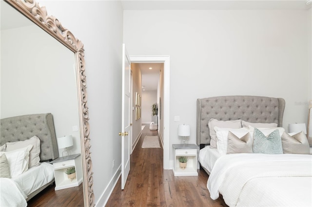 bedroom with wood finished floors and baseboards