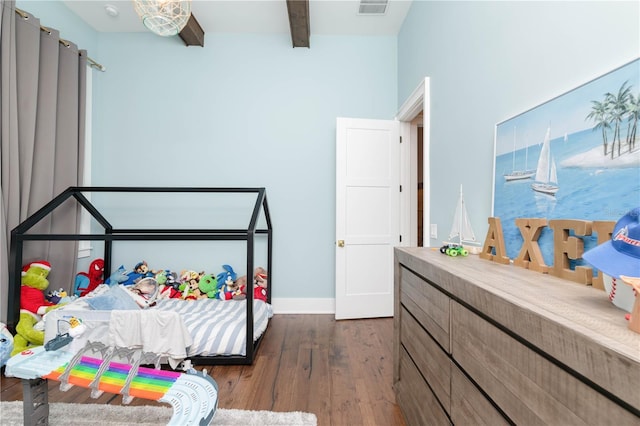 bedroom featuring dark wood-style flooring, visible vents, beamed ceiling, and baseboards