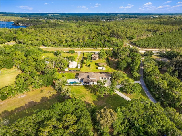 birds eye view of property with a water view and a view of trees