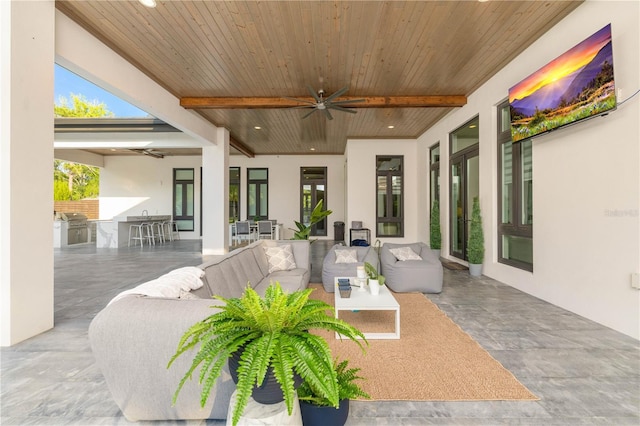 view of patio / terrace featuring exterior kitchen, grilling area, an outdoor living space, and a ceiling fan