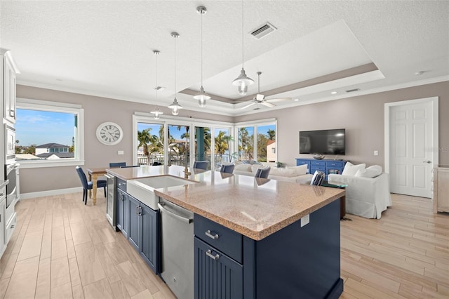 15904 Redington Dr, Redington Beach, FL 33708 - kitchen featuring light wood-style flooring, stainless steel appliances, visible vents, blue cabinetry, and a tray ceiling