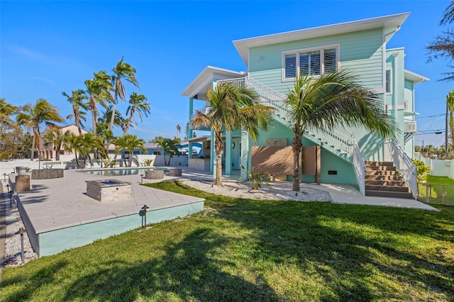 15904 Redington Dr, Redington Beach, FL 33708 - back of house featuring fence, a patio, a lawn, and stairs