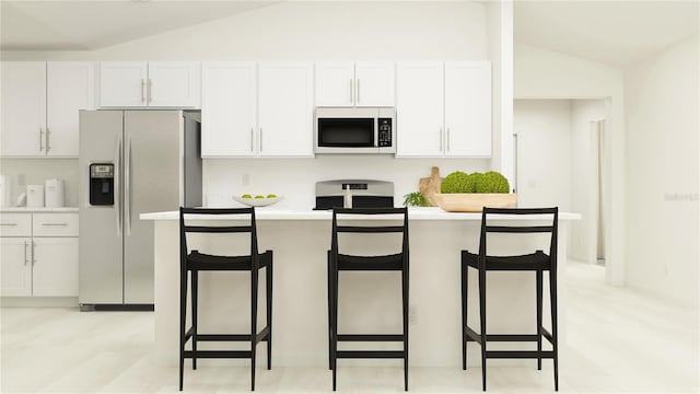 kitchen with lofted ceiling, a breakfast bar, stainless steel refrigerator with ice dispenser, and white cabinetry