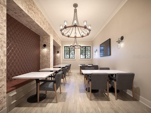 recreation room featuring ornamental molding, a notable chandelier, baseboards, and wood finished floors