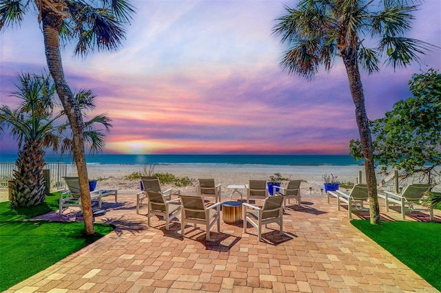 view of patio featuring a beach view and a water view