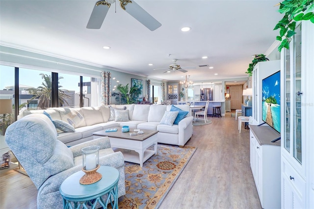 living area with recessed lighting, ceiling fan, crown molding, and light wood finished floors