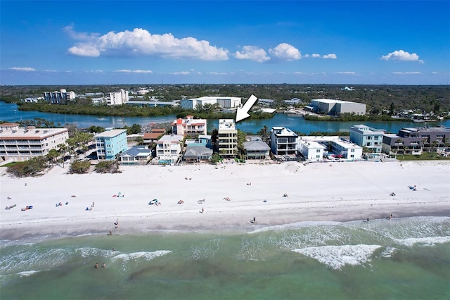 birds eye view of property featuring a water view and a beach view