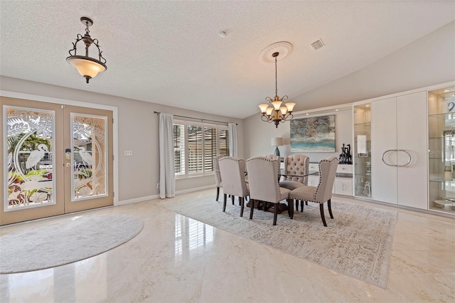 dining space featuring lofted ceiling, marble finish floor, visible vents, and french doors