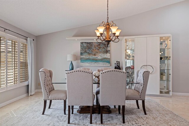 dining area with lofted ceiling, an inviting chandelier, baseboards, and a textured ceiling