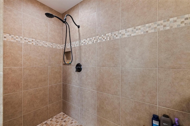 bathroom with a tile shower